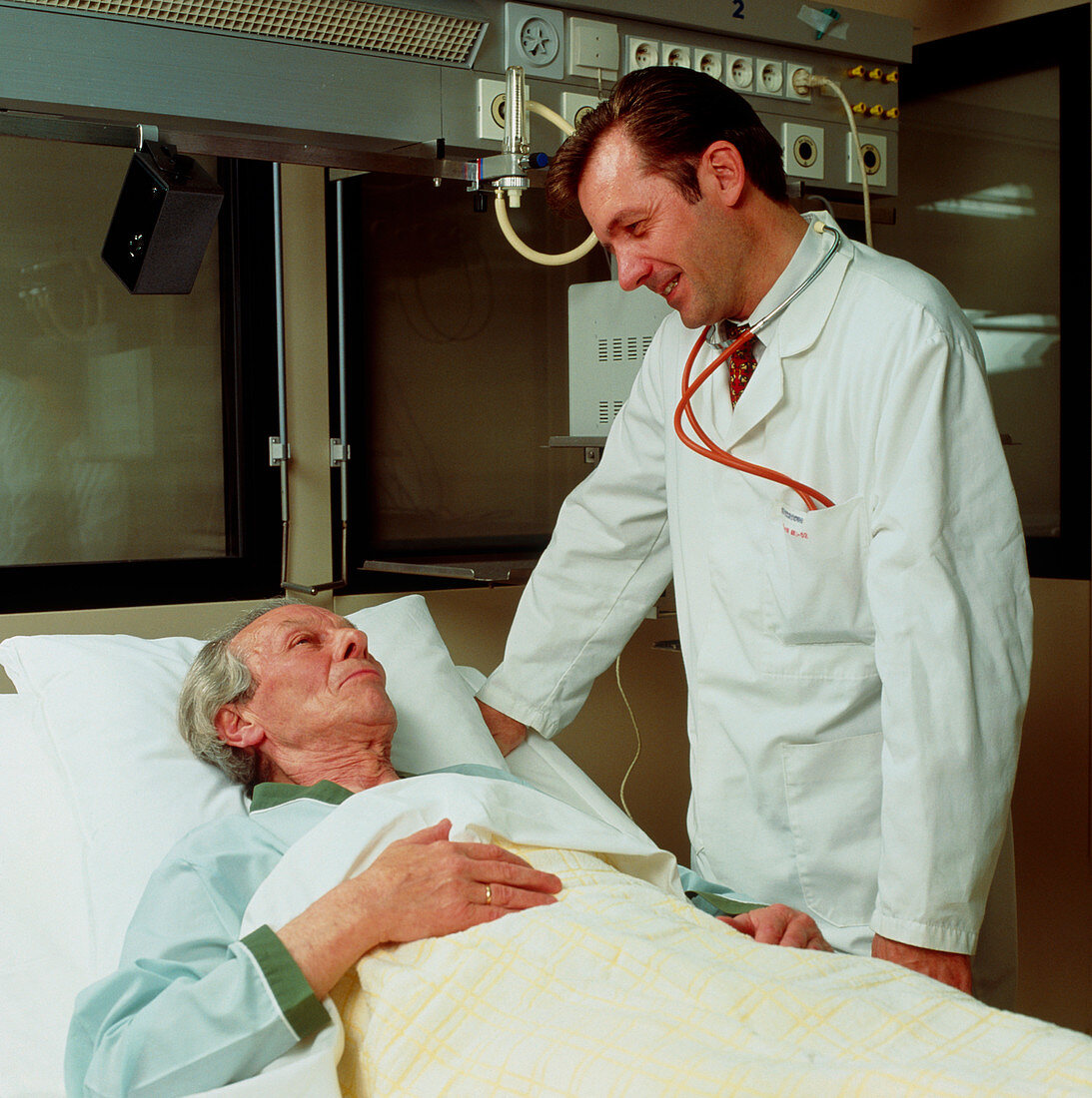 Doctor attends elderly man in a geriatric ward
