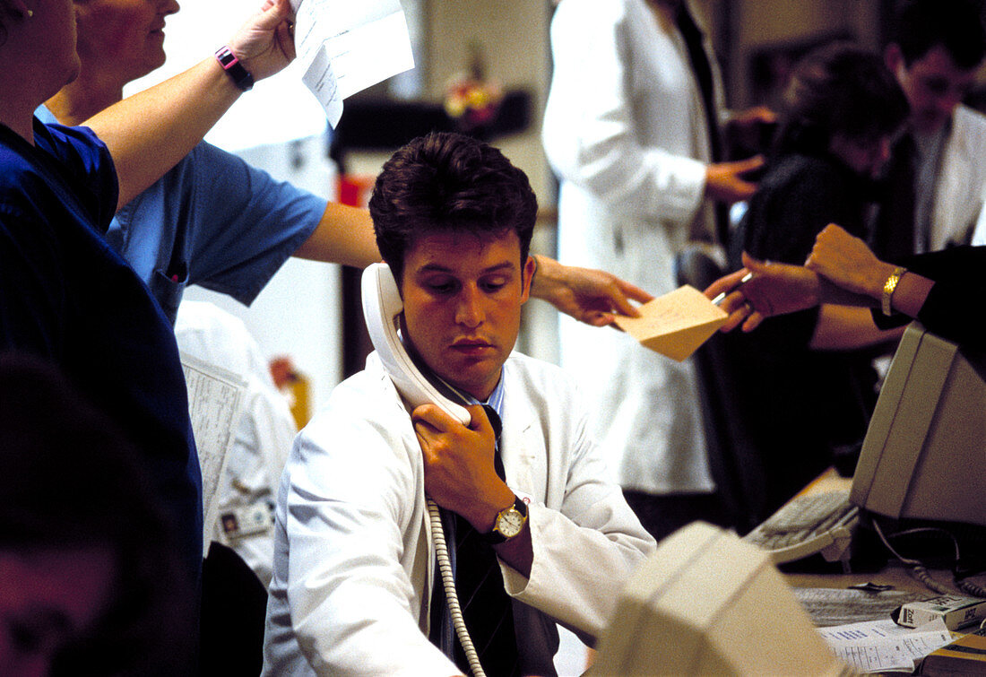 Hospital doctor using a telephone