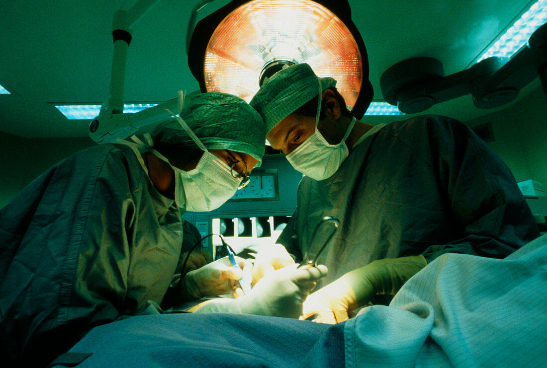 Surgeons operating on a cancerous breast