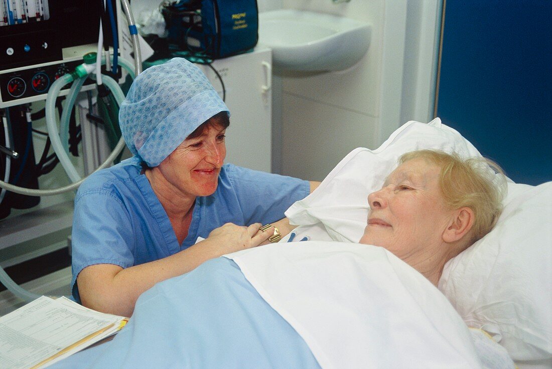 Operating theatre nurse with a patient