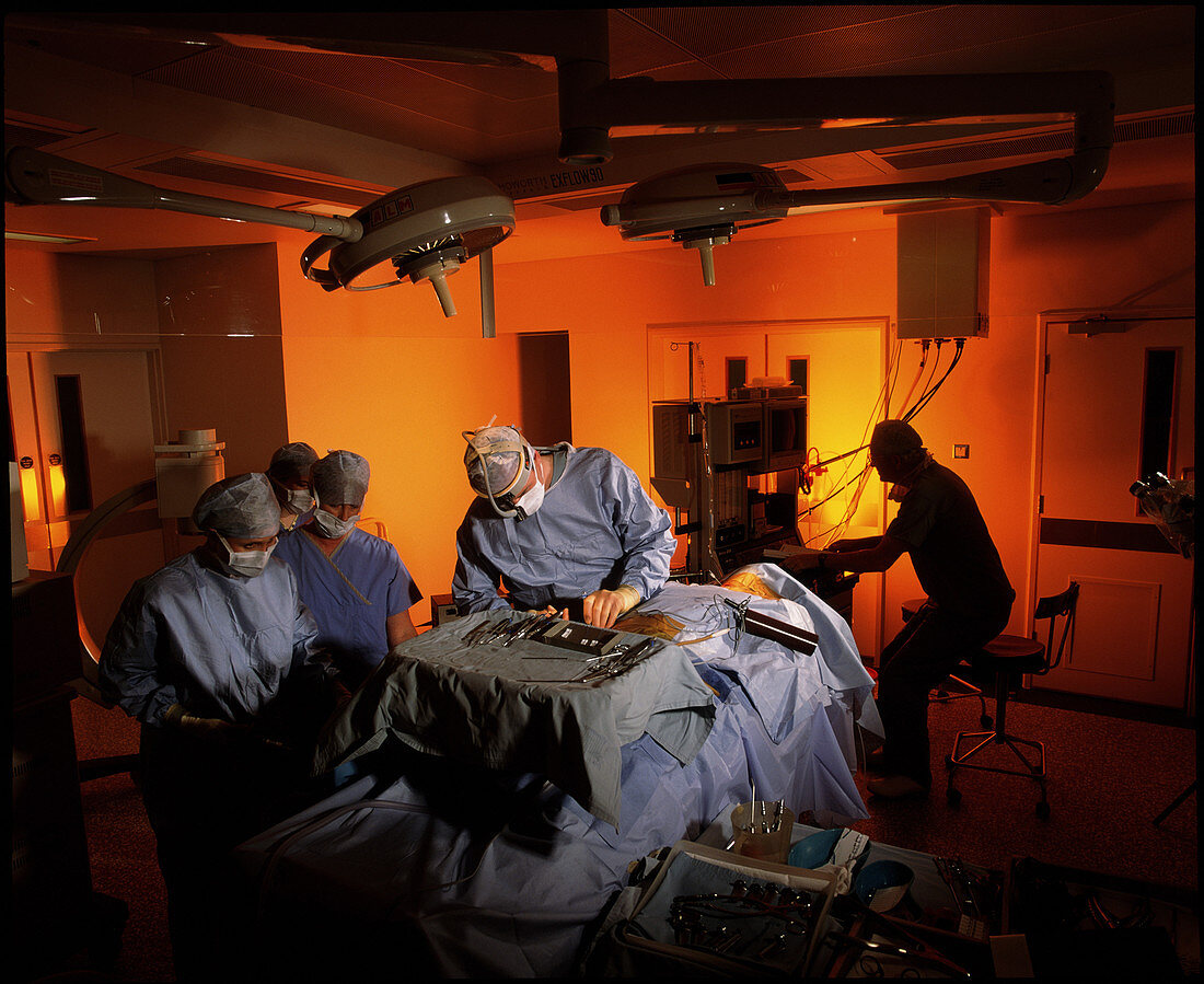 Surgical team performing a neck fusion operation
