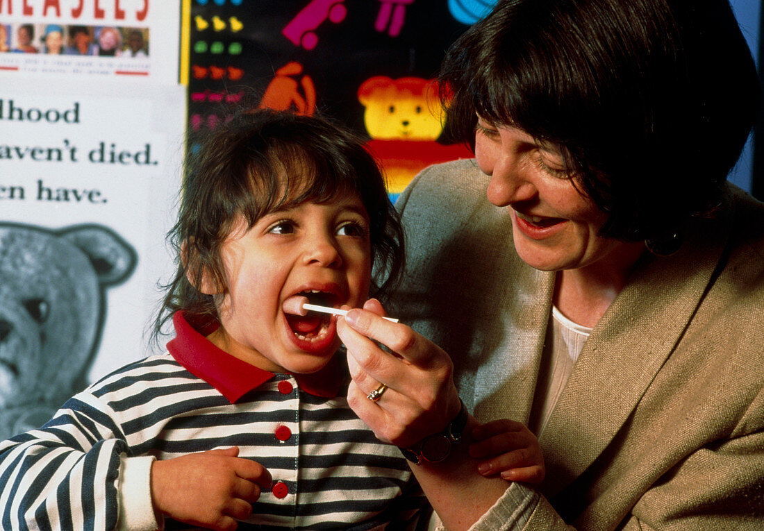 Child having oral swab test for measles/rubella