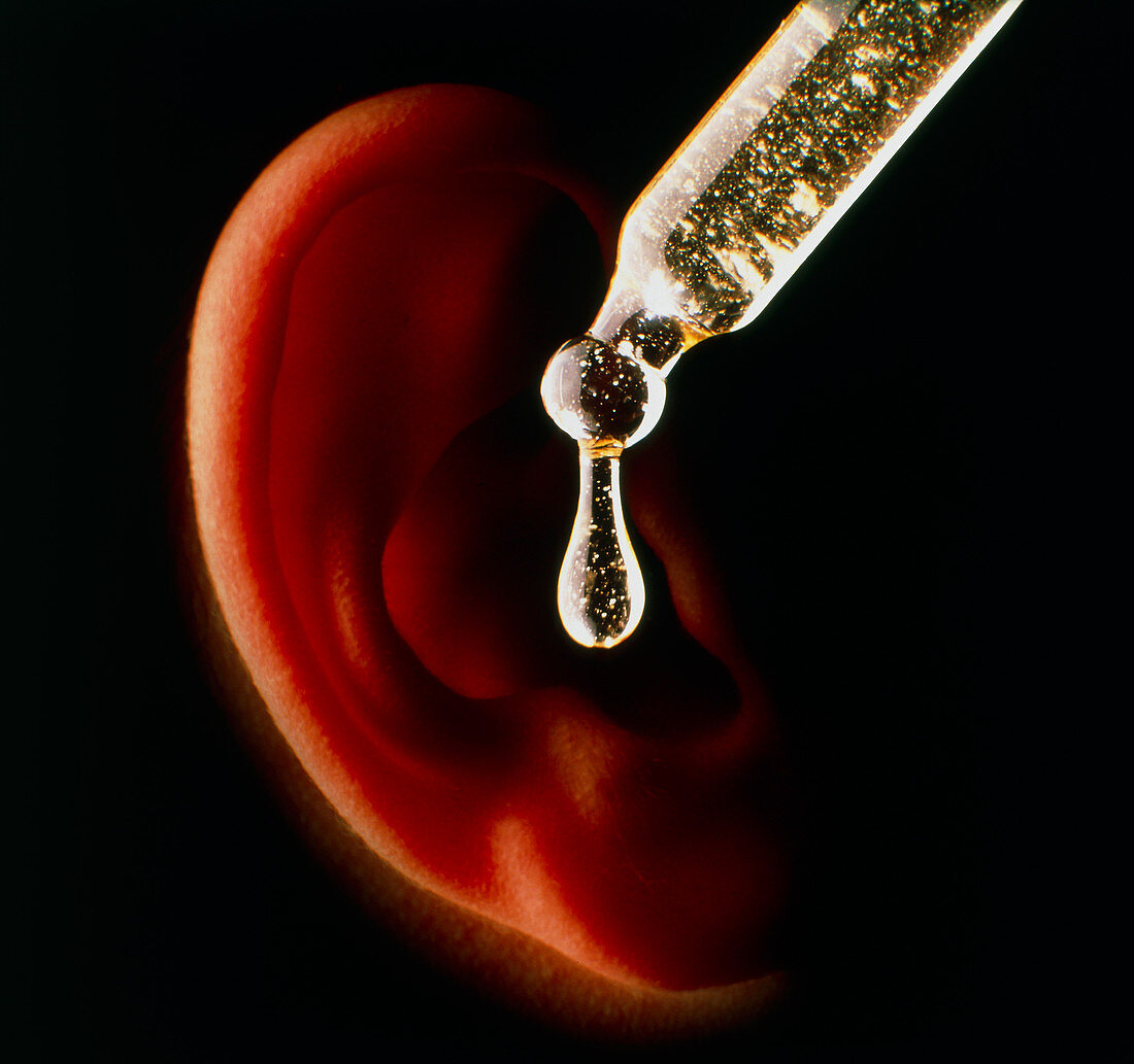Patient's ear near an ear dropper