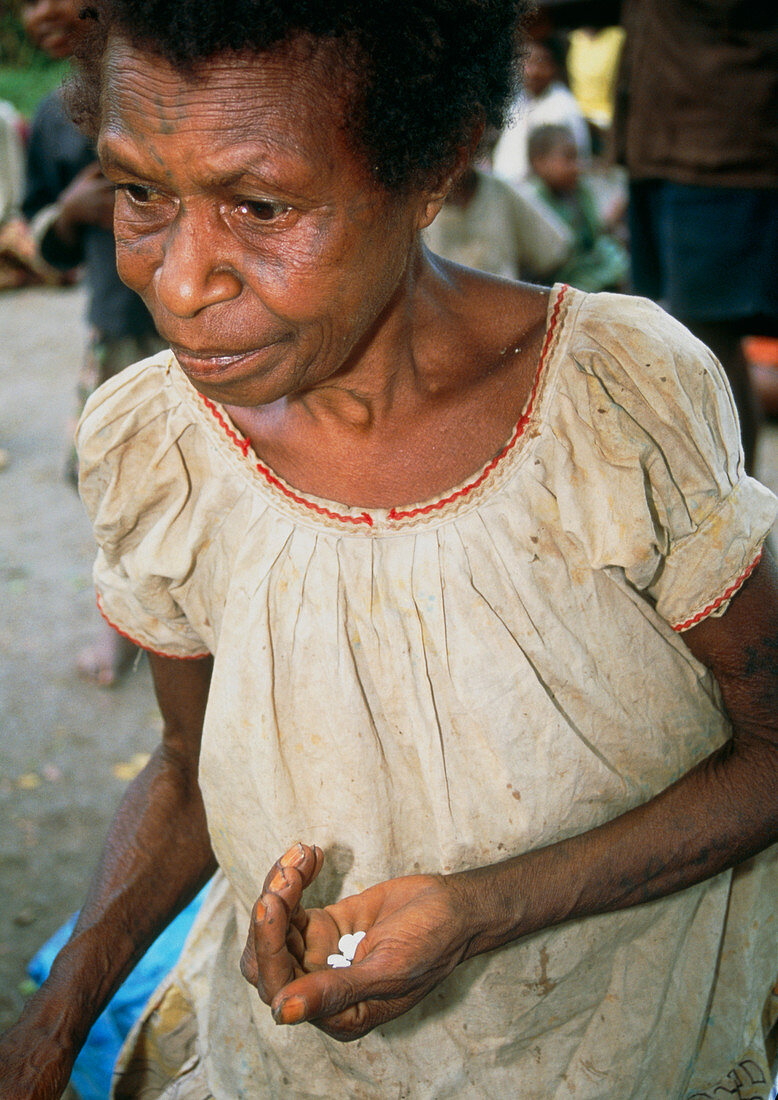 Woman holding pills of elephantiasis drugs