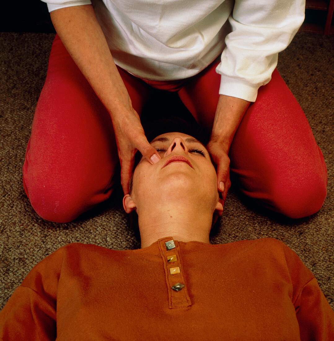 Woman receiving facial Shiatsu massage