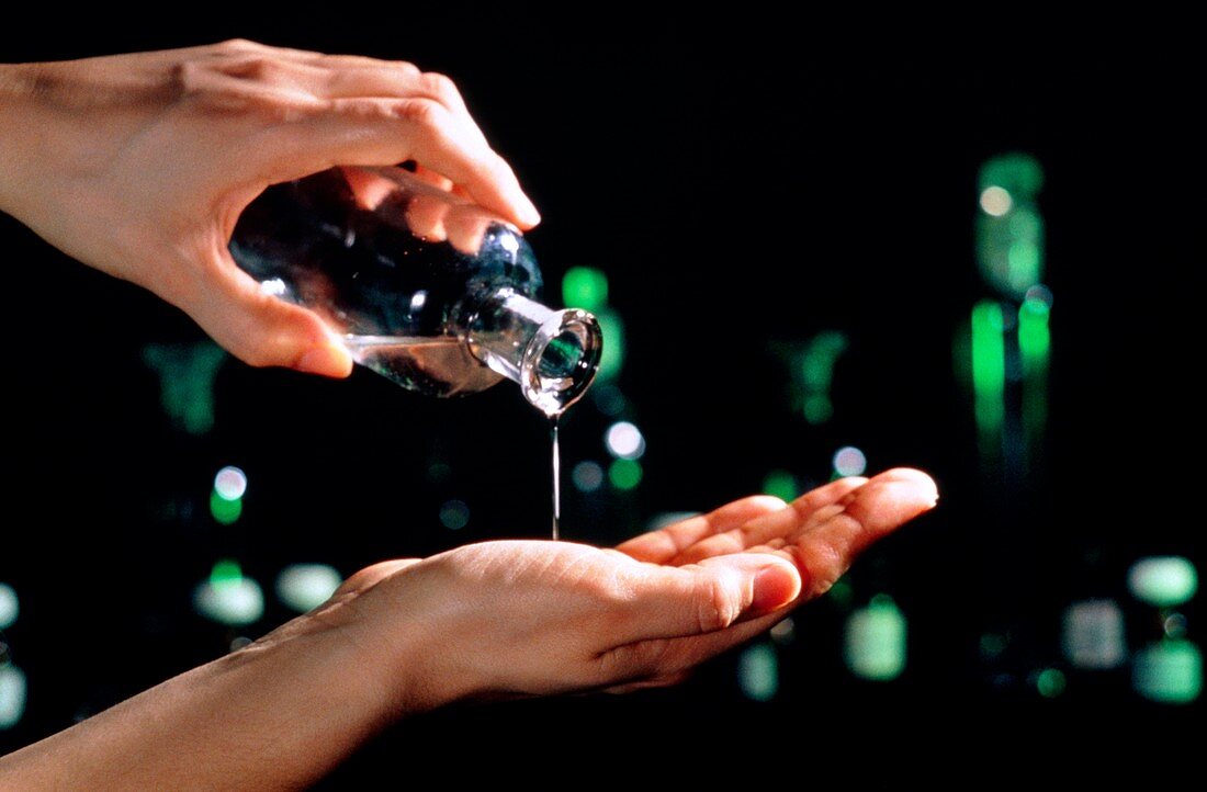 Aromatherapy oil being poured onto a hand