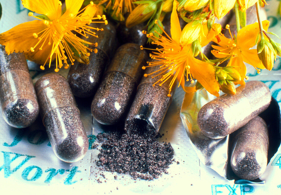 Pills and flowers of St John's wort,Hypericum sp