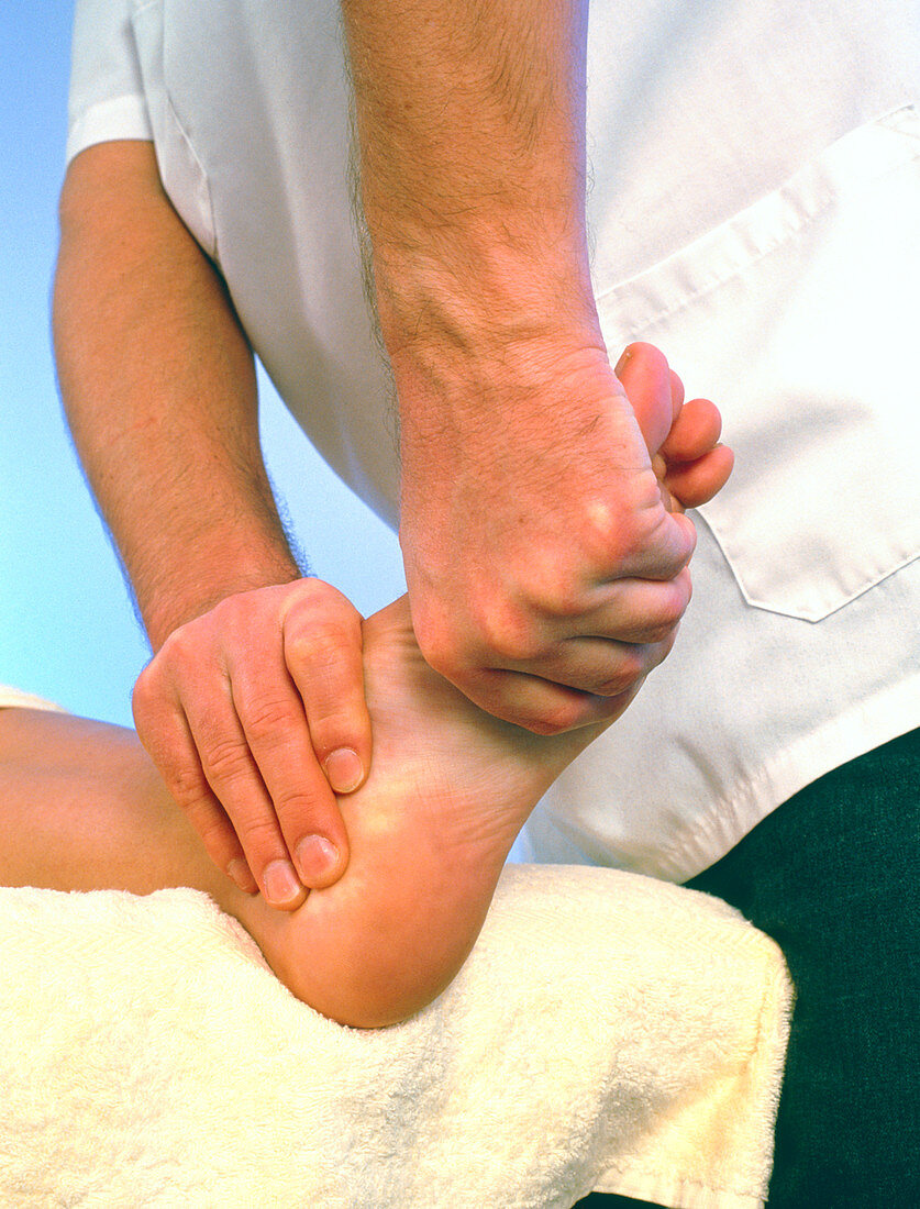 Osteopath treating the foot of a patient