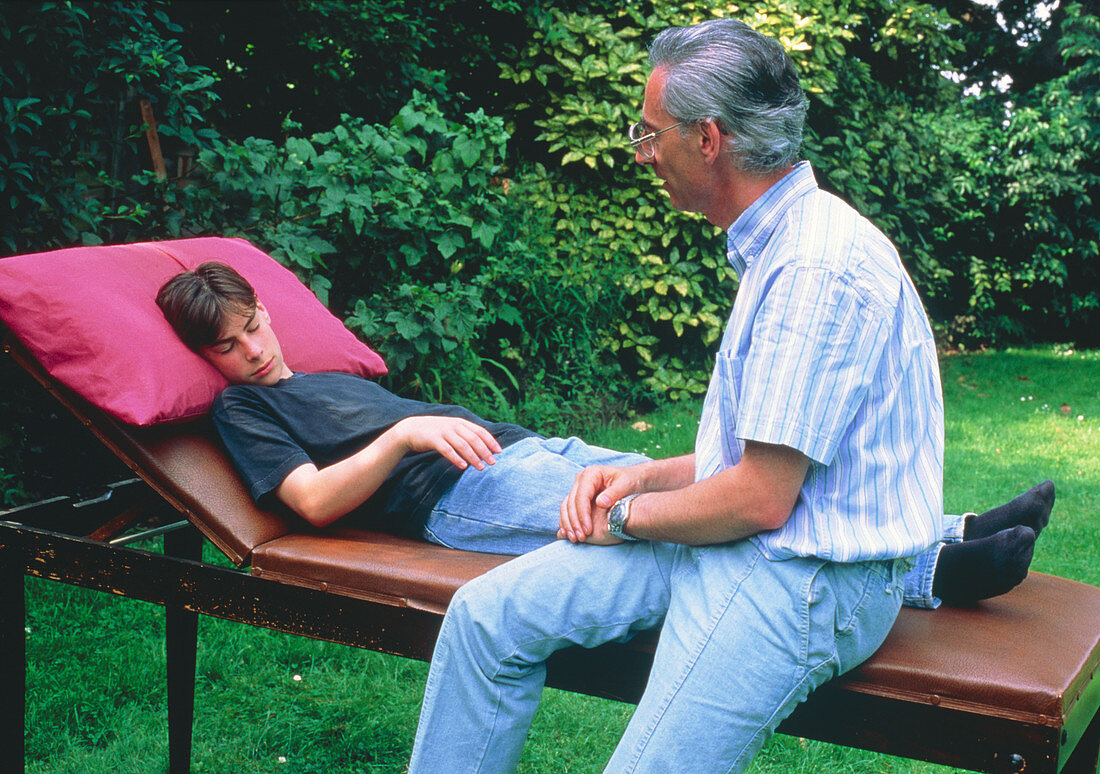 Hypnotherapist with young male subject