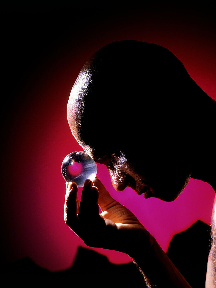 Abstract image of man gazing into a crystal ball