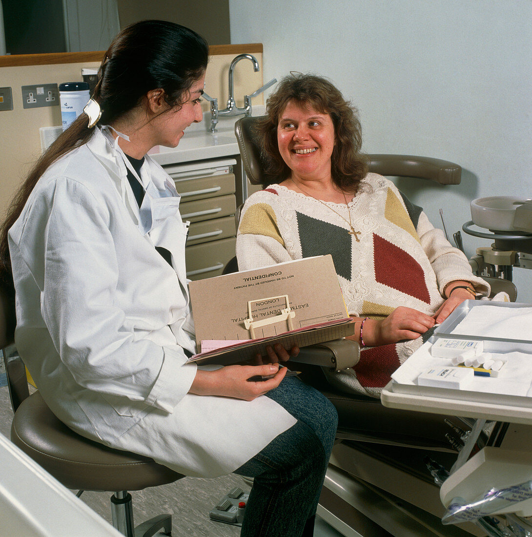 Dental hygienist consults with woman