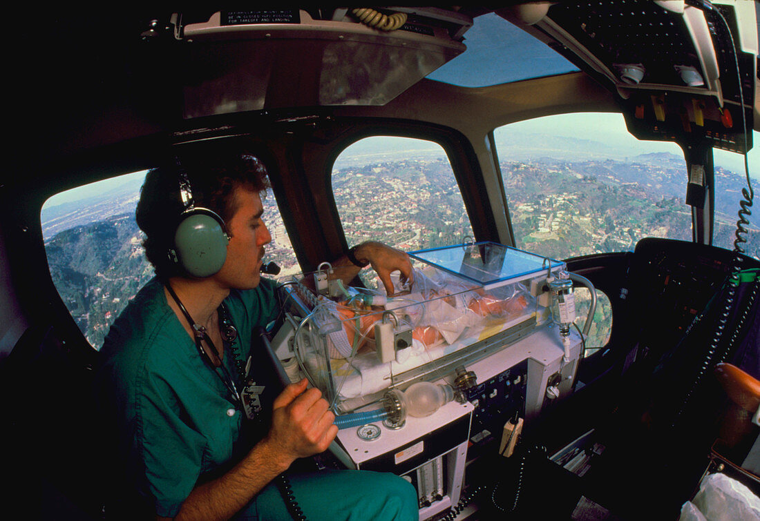 Newborn baby in an incubator in an air ambulance