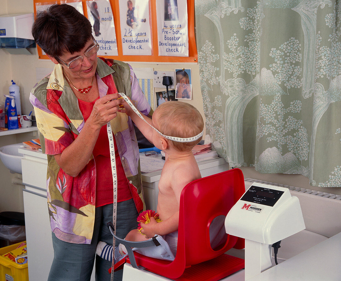 Baby being weighed and measured during checkup