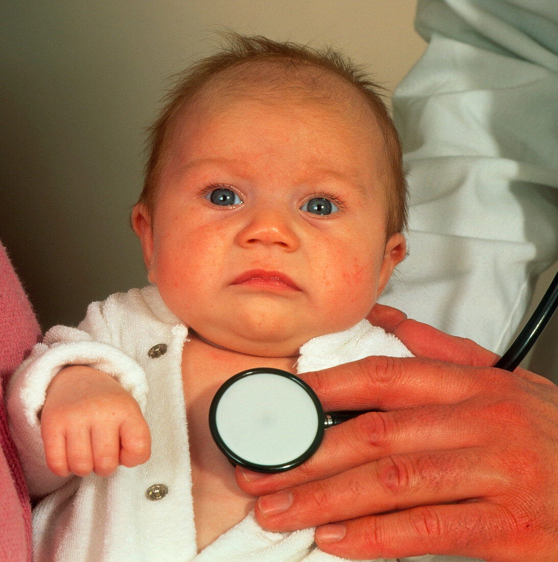 Doctor examining baby girl