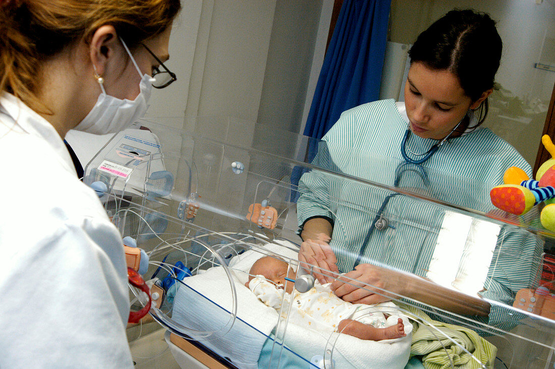 Doctors with a premature baby