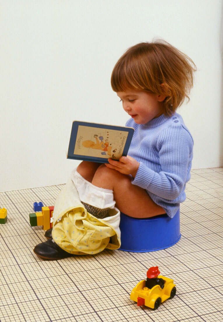 Pot training: young child sitting on a pot