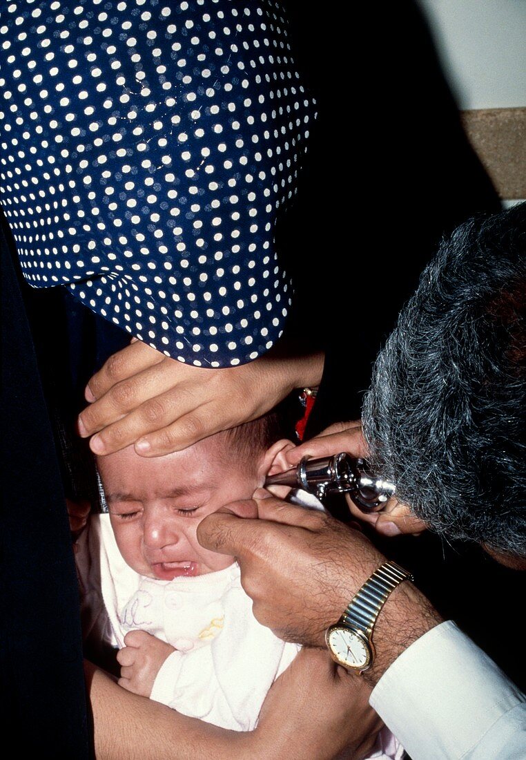 Doctor examining the ear of a baby