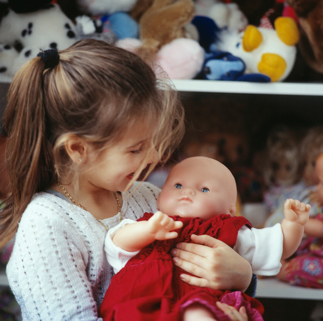 Girl holding doll