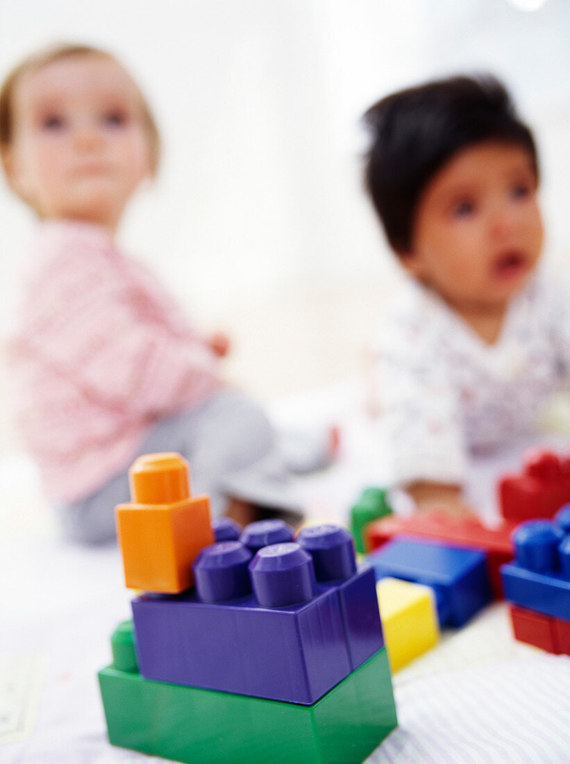 Babies with building blocks