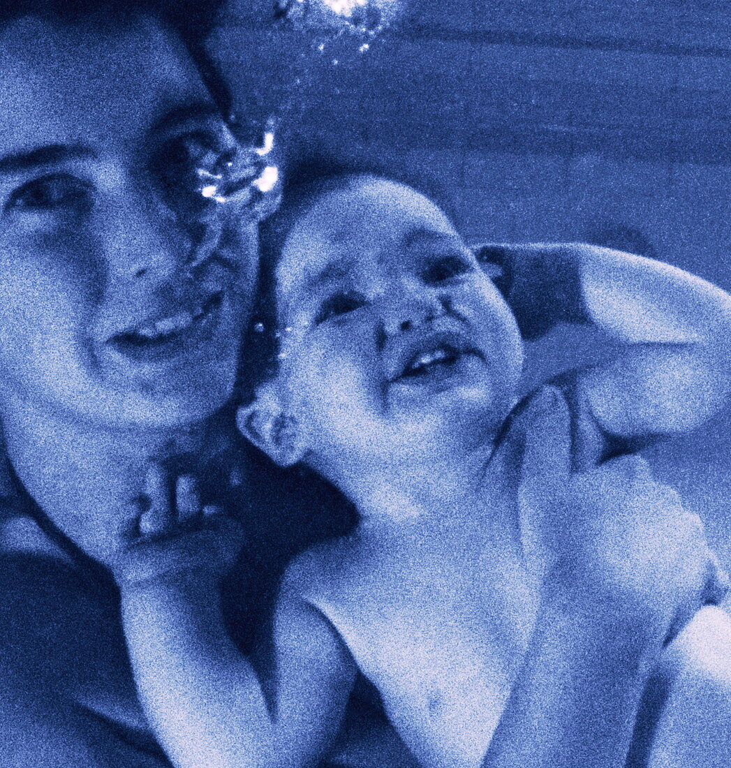 Baby underwater with its mother