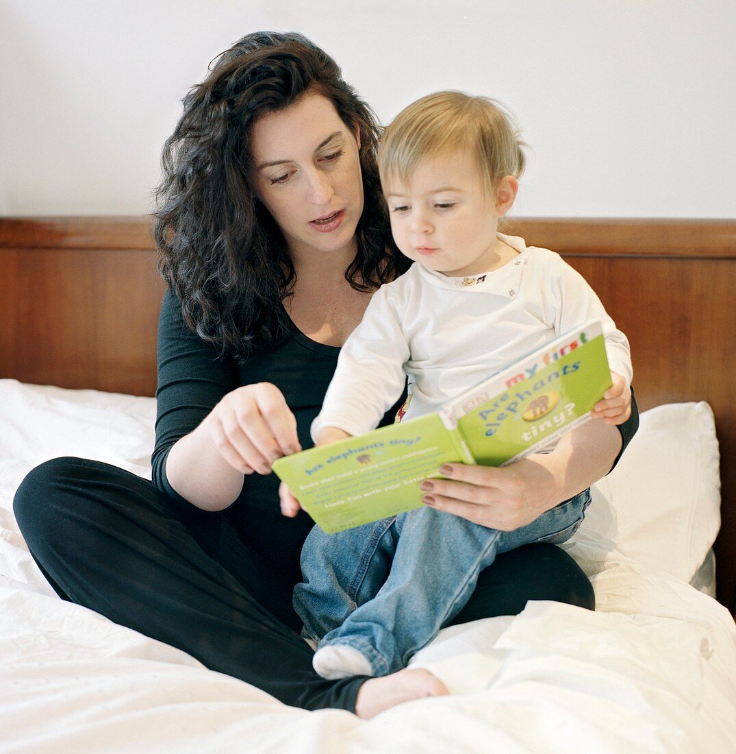 Pregnant mother reading to her child