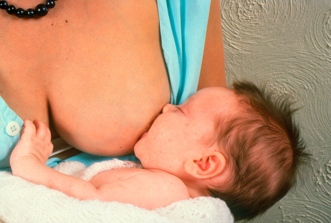 Mother breast-feeding her six-week-old daughter