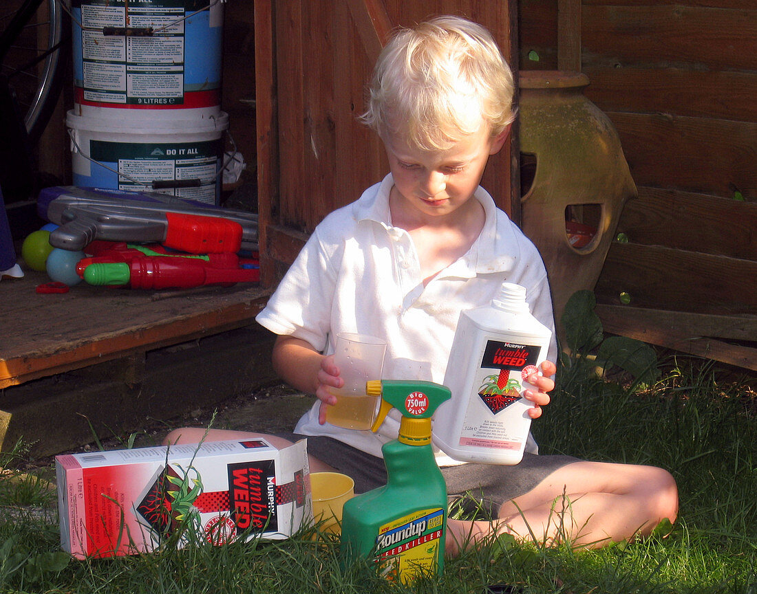 Child playing with weedkiller