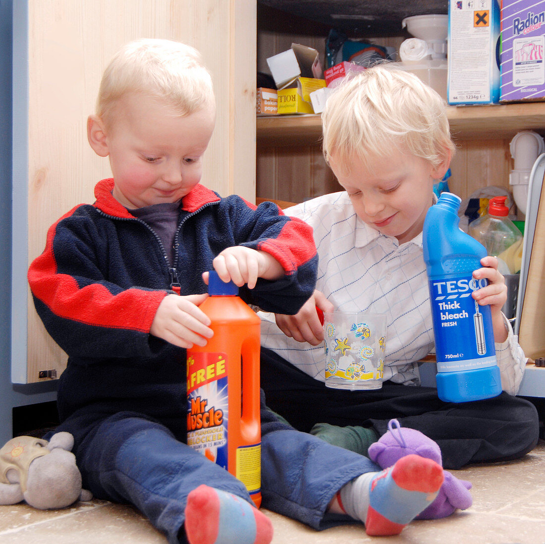 Children playing with cleaning products