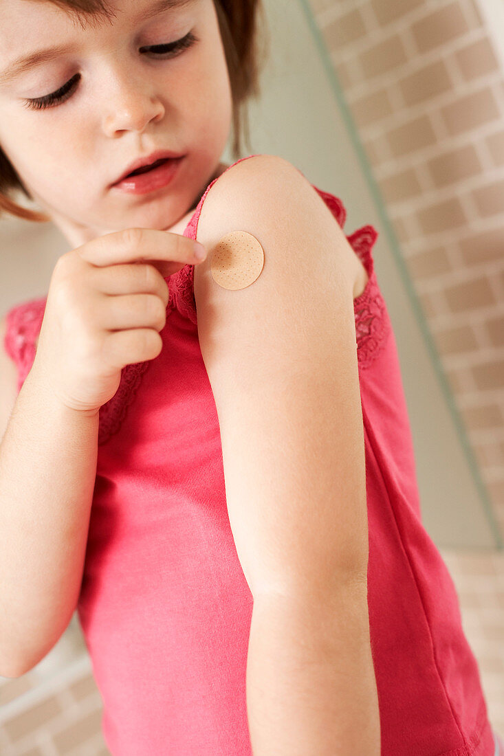 Girl applying a plaster