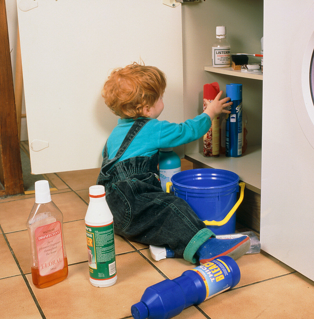 Child safety; child playing with bottles of bleach
