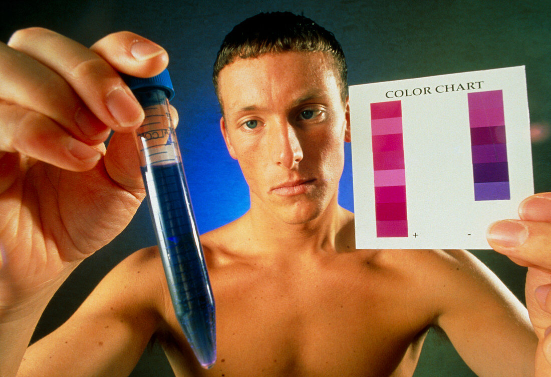 Man holding up a fertility colour-test