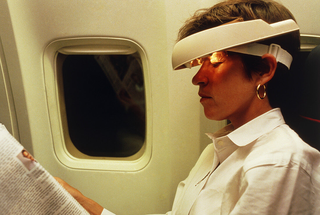 Woman wearing Jet Lag Visor during plane flight