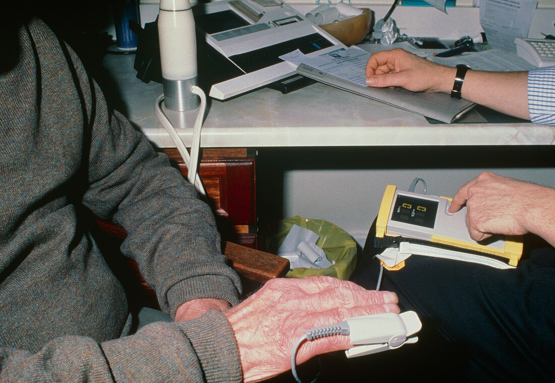 Digital oximeter used on finger of elderly man