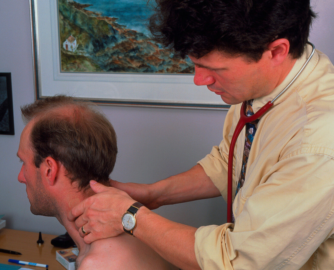 Doctor examining a man's neck