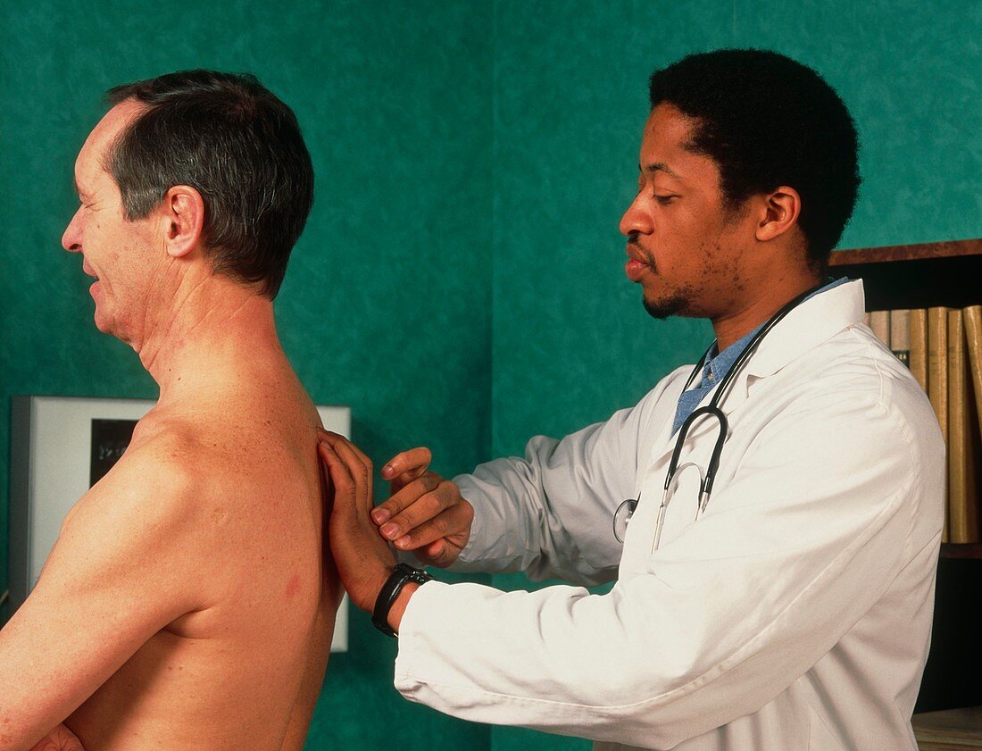 GP doctor performs percussion chest examination