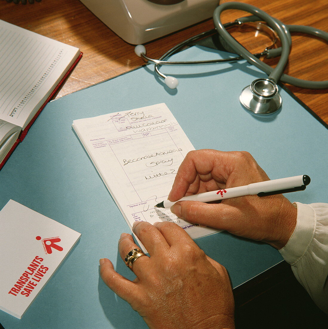 General practitioner writing a prescription
