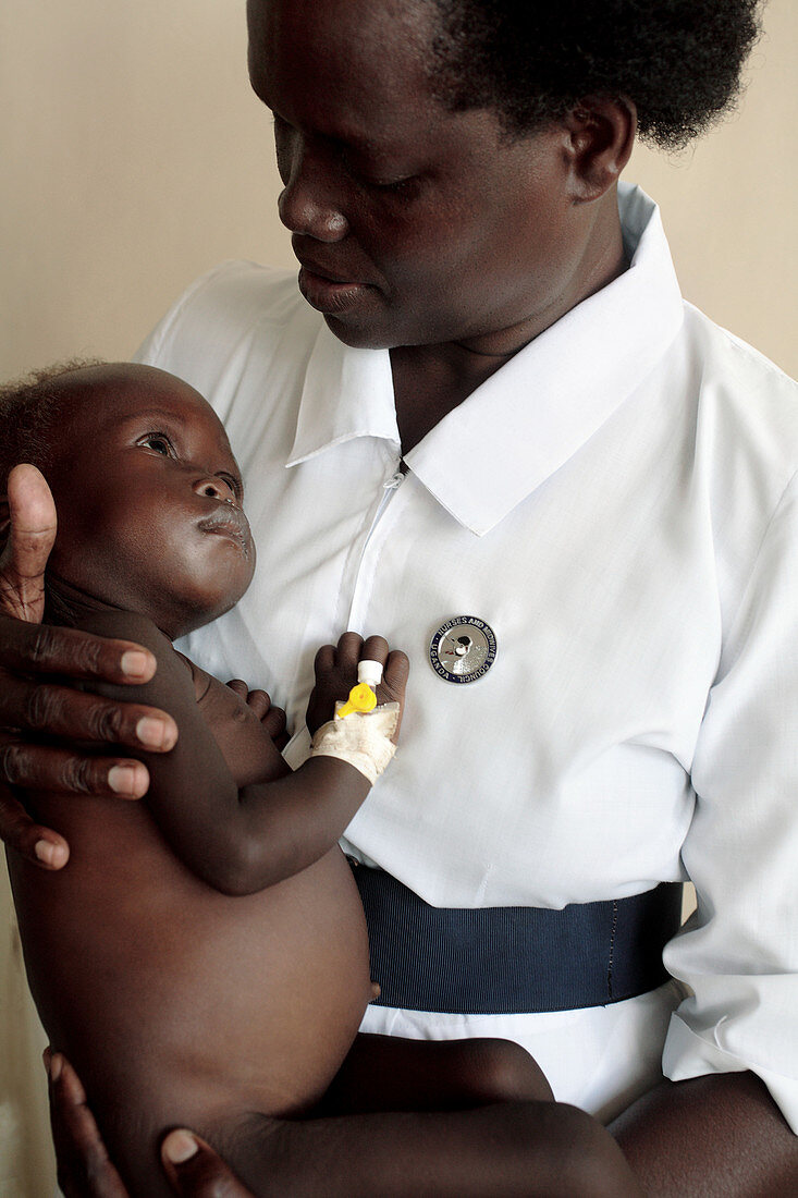 Nurse holding a malnourished baby