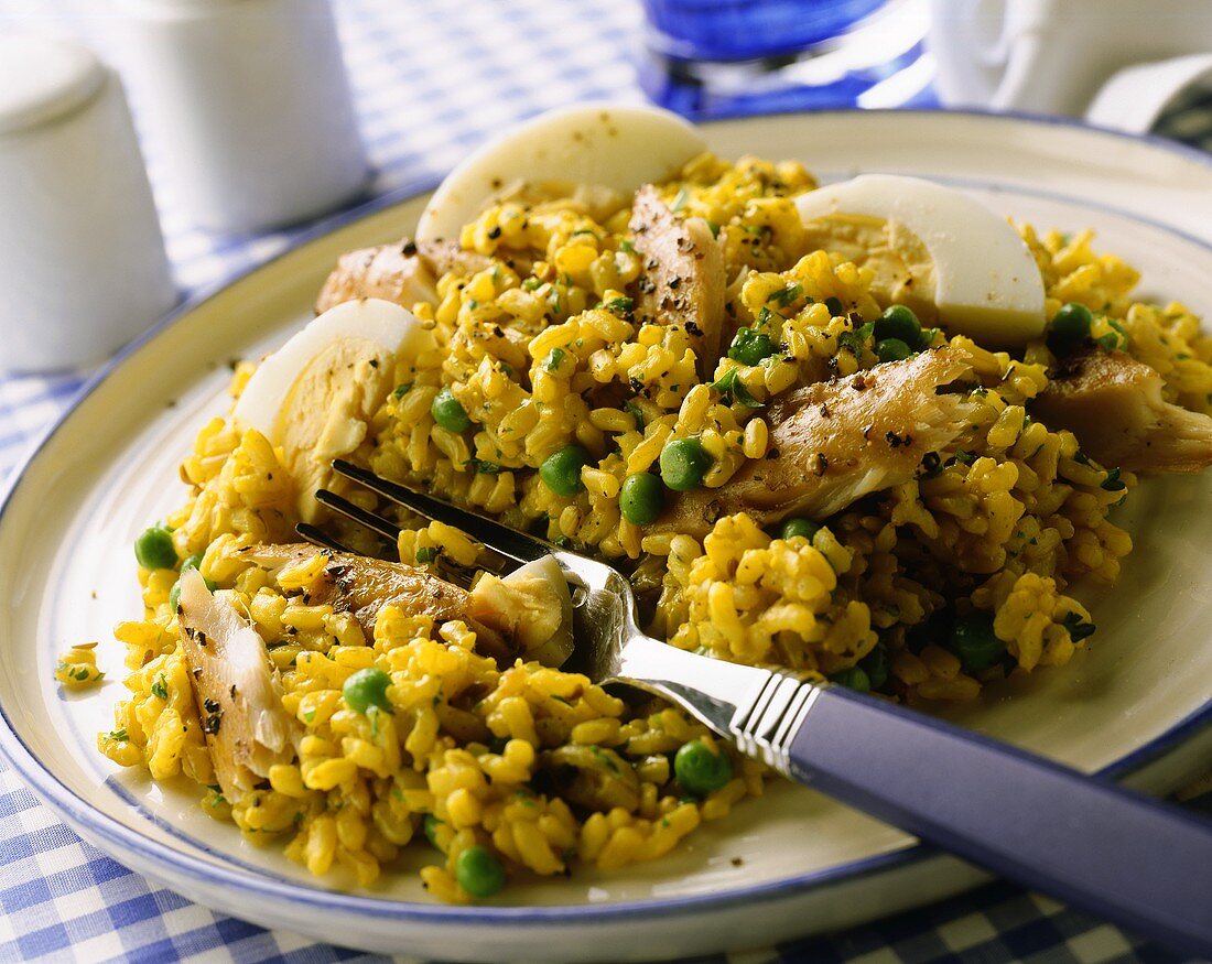 Saffron rice with mackerel fillets, eggs & peas on plate