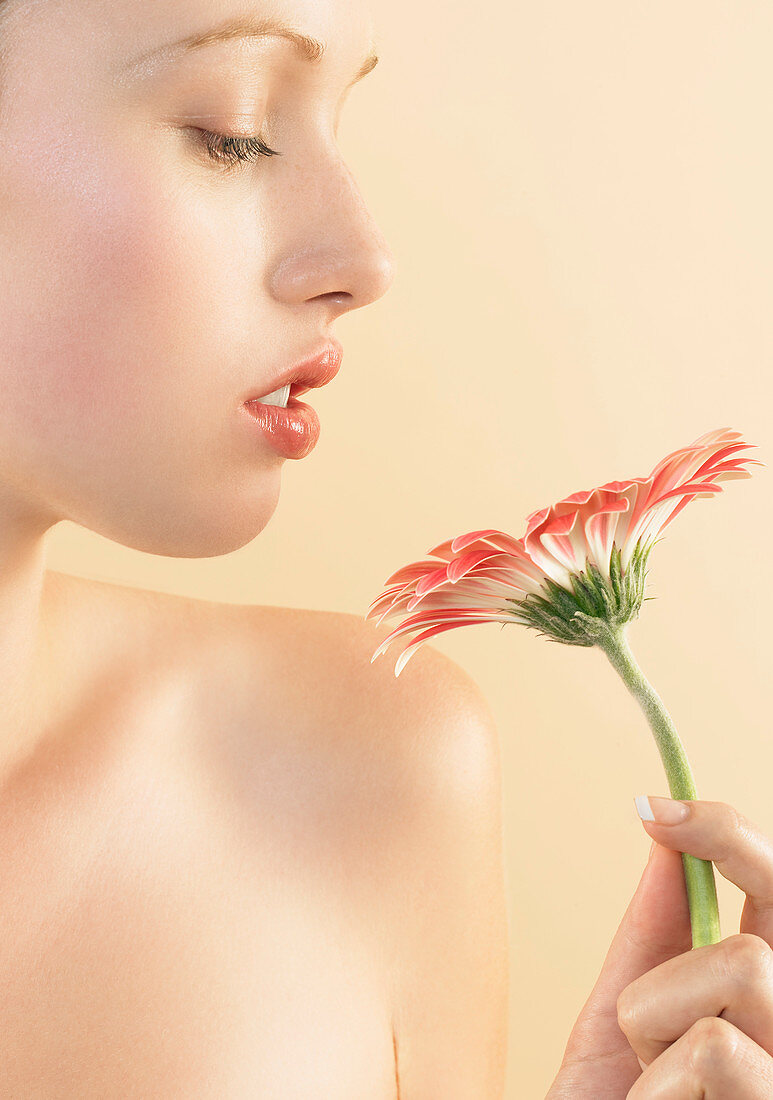 Woman smelling a flower