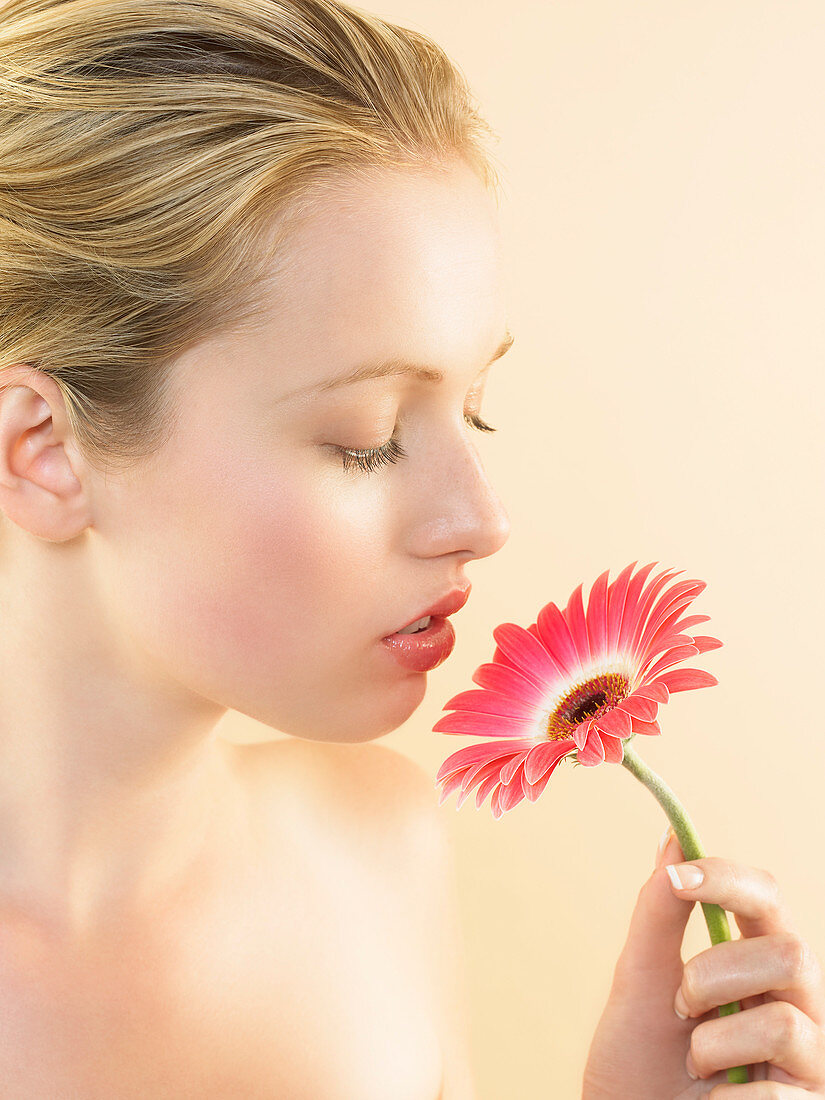 Woman smelling a flower