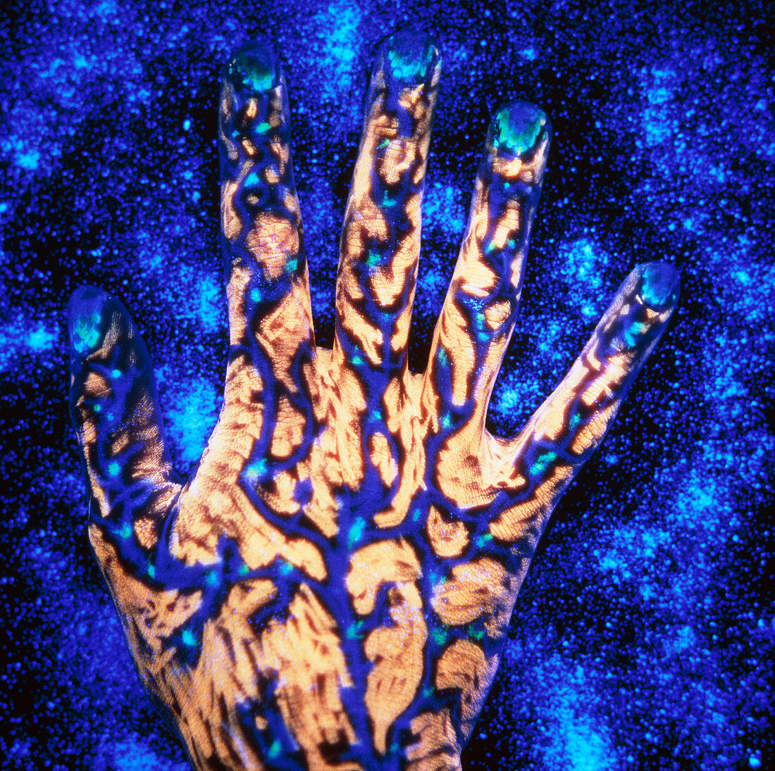 Fluorescent ink on hand,starry blue background