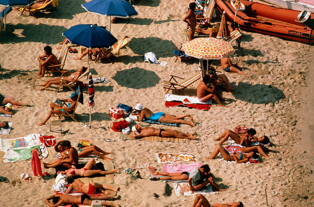 People sunbathing on a Sardinian beach