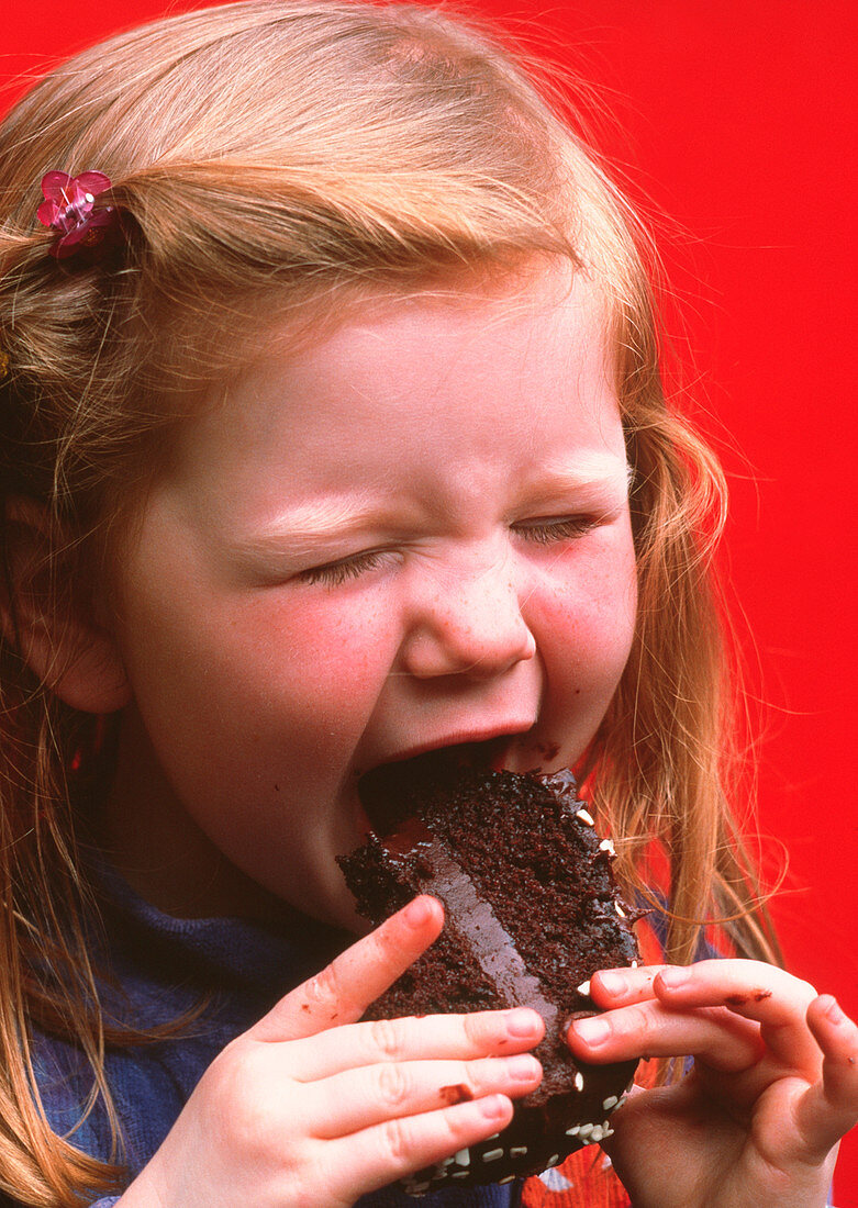 Young girl eating cake