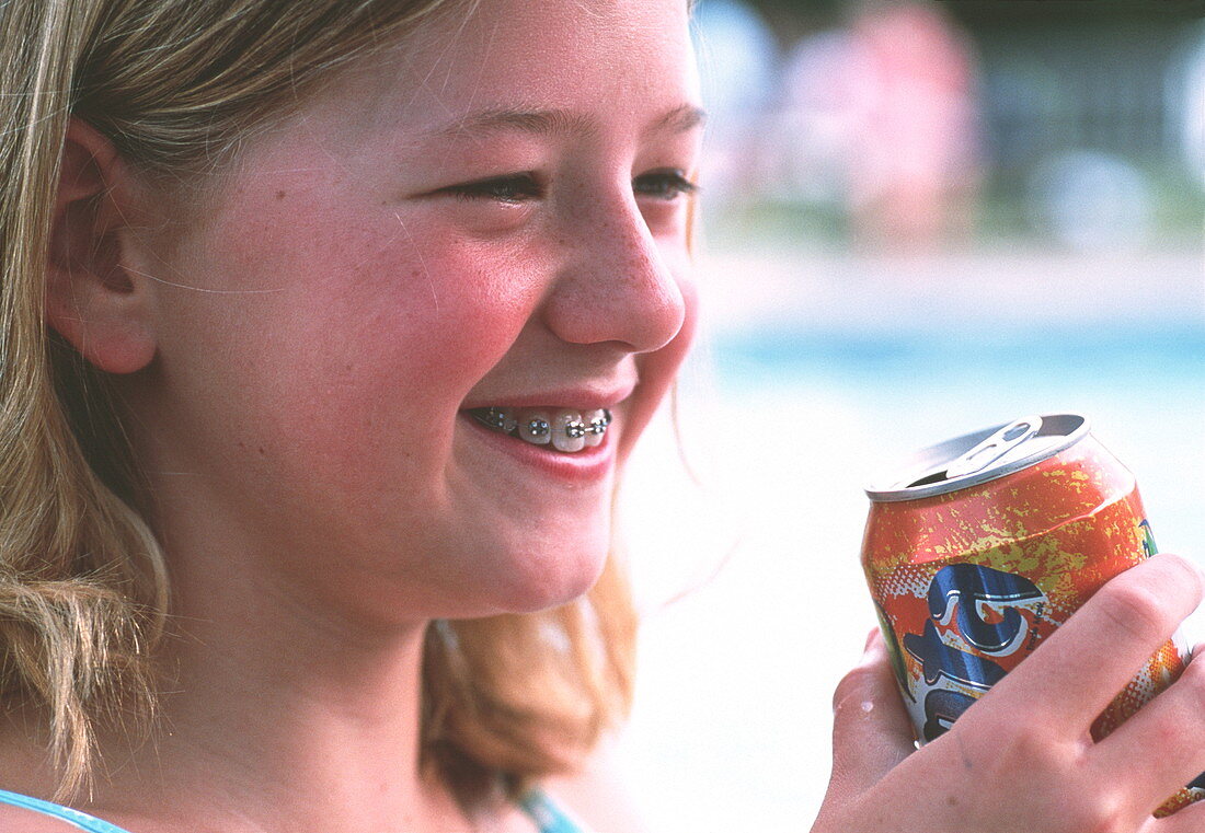Young girl drinking soft drink