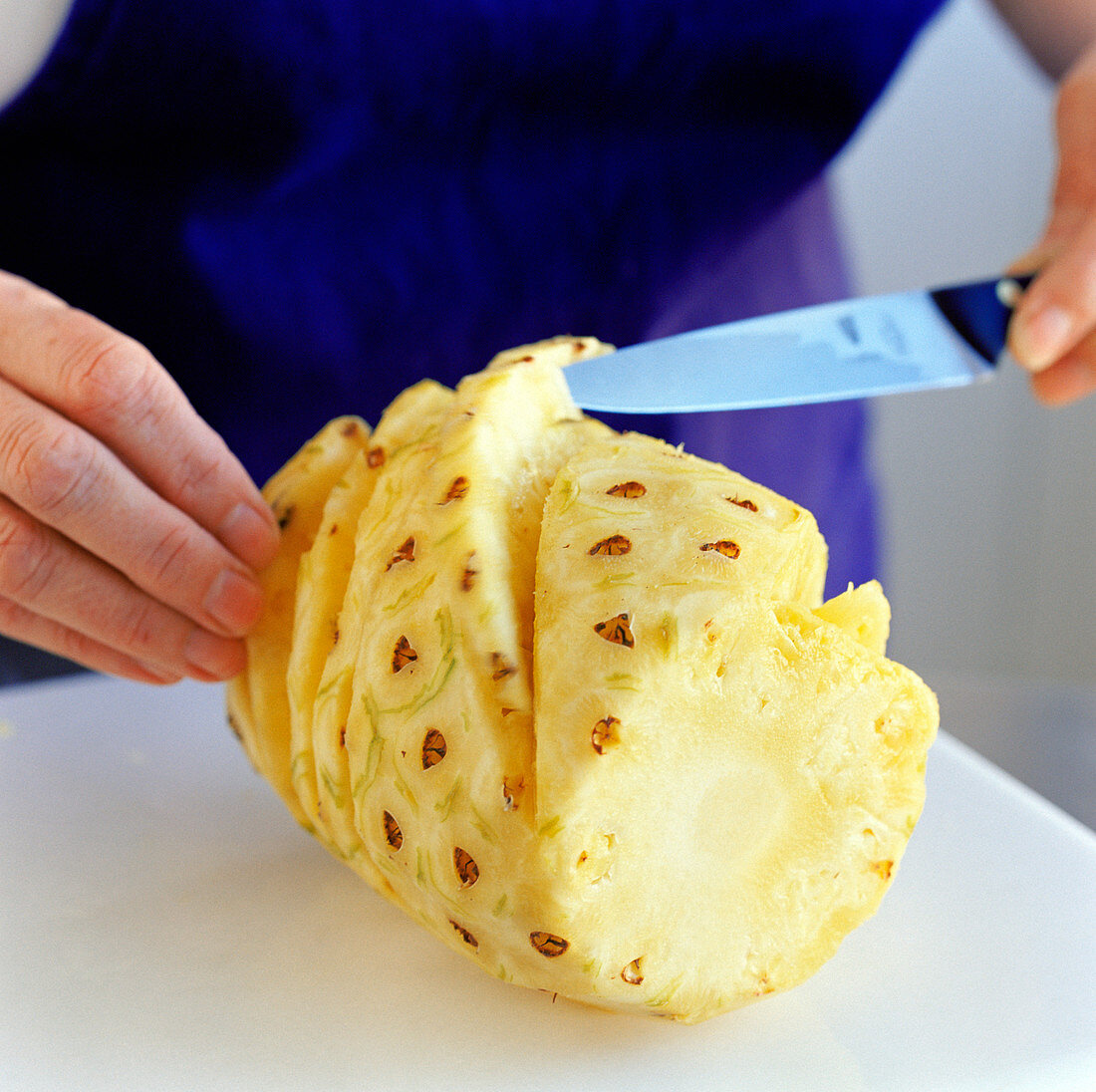 Slicing a pineapple