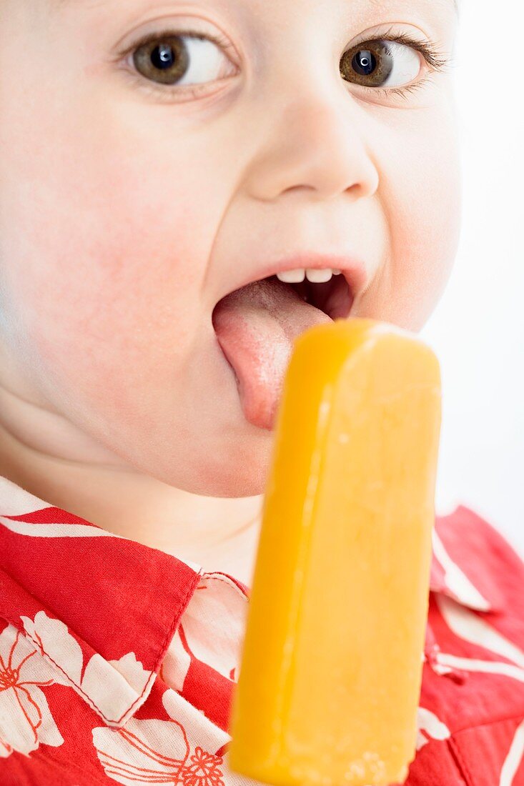 Toddler licking an ice lolly