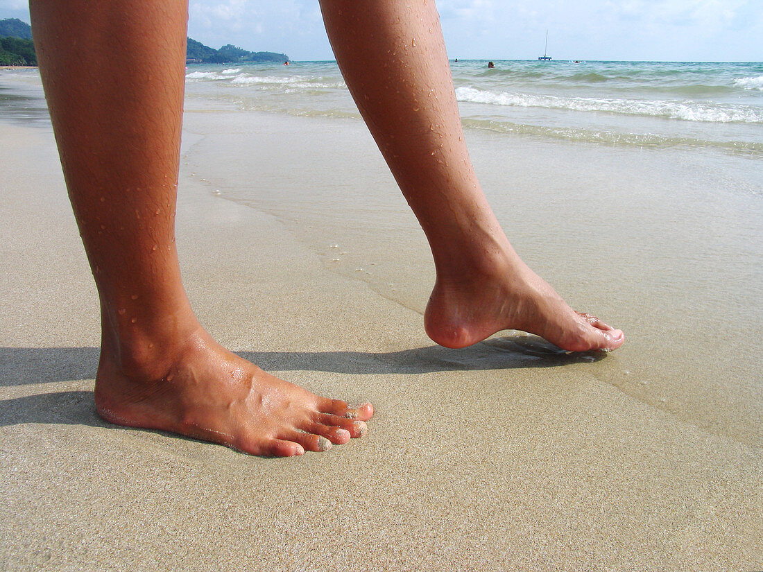 Woman dipping her toe in the sea