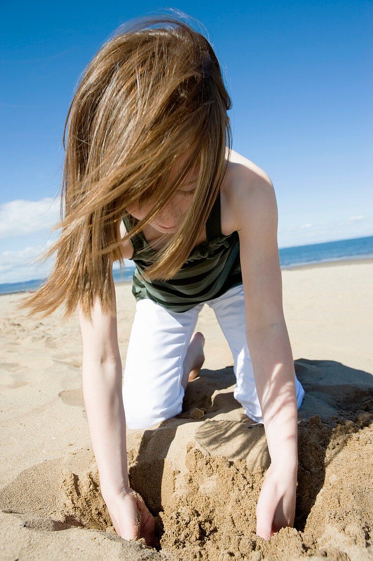 Girl playing with sand