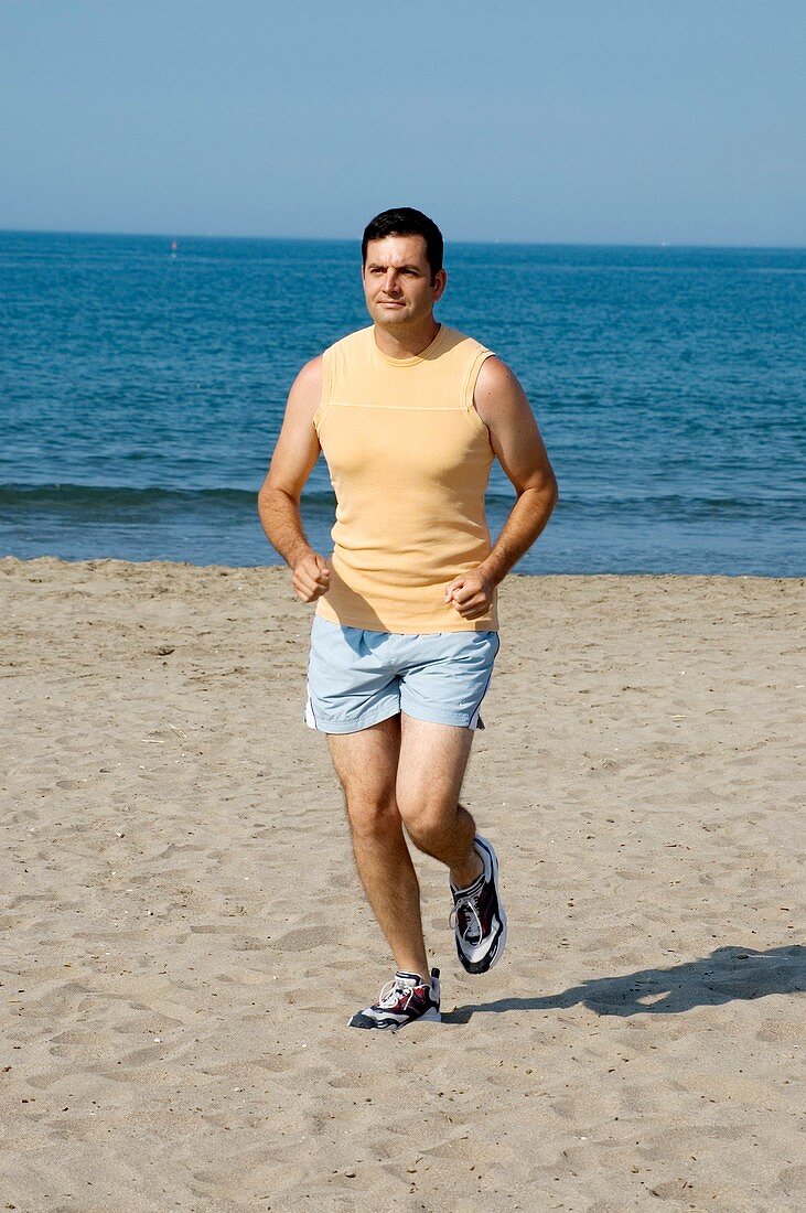 Man jogging along a beach