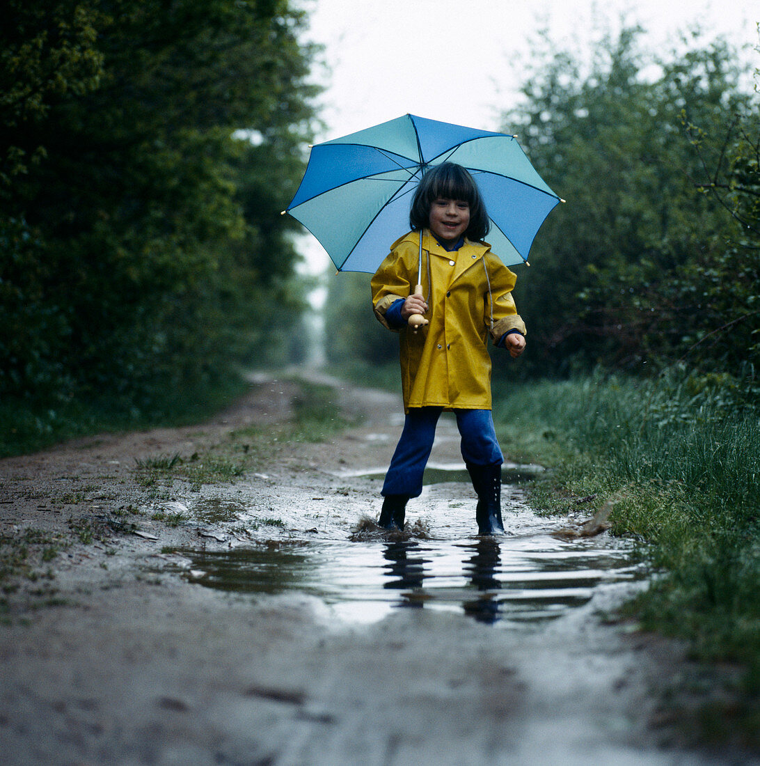 Girl walking in a puddle